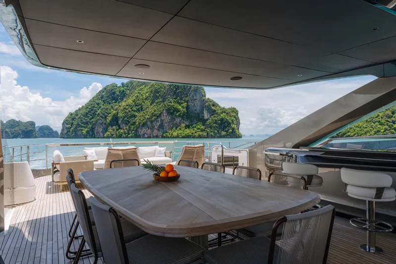  Yacht Photos Pics Luxurious 2023 Princess Y95 yacht deck with ocean view and island backdrop.