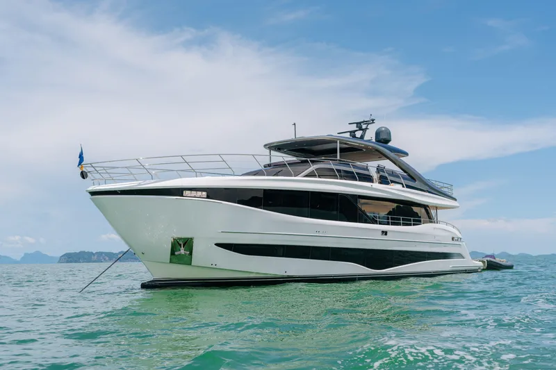  Yacht Photos Pics Luxurious 2023 Princess Y95 yacht cruising on clear blue waters under a sunny sky.