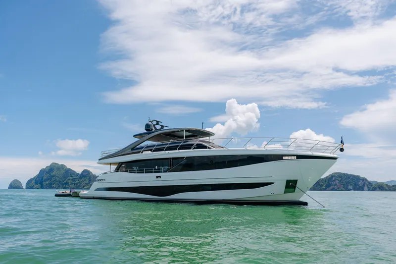  Yacht Photos Pics Luxury Princess Y95 yacht on serene waters, 2023 model, with scenic island backdrop.