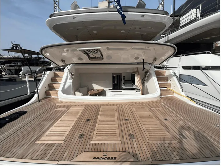  Yacht Photos Pics Luxury Princess Y95 yacht, 2023 model, featuring spacious teak deck and open rear compartment.