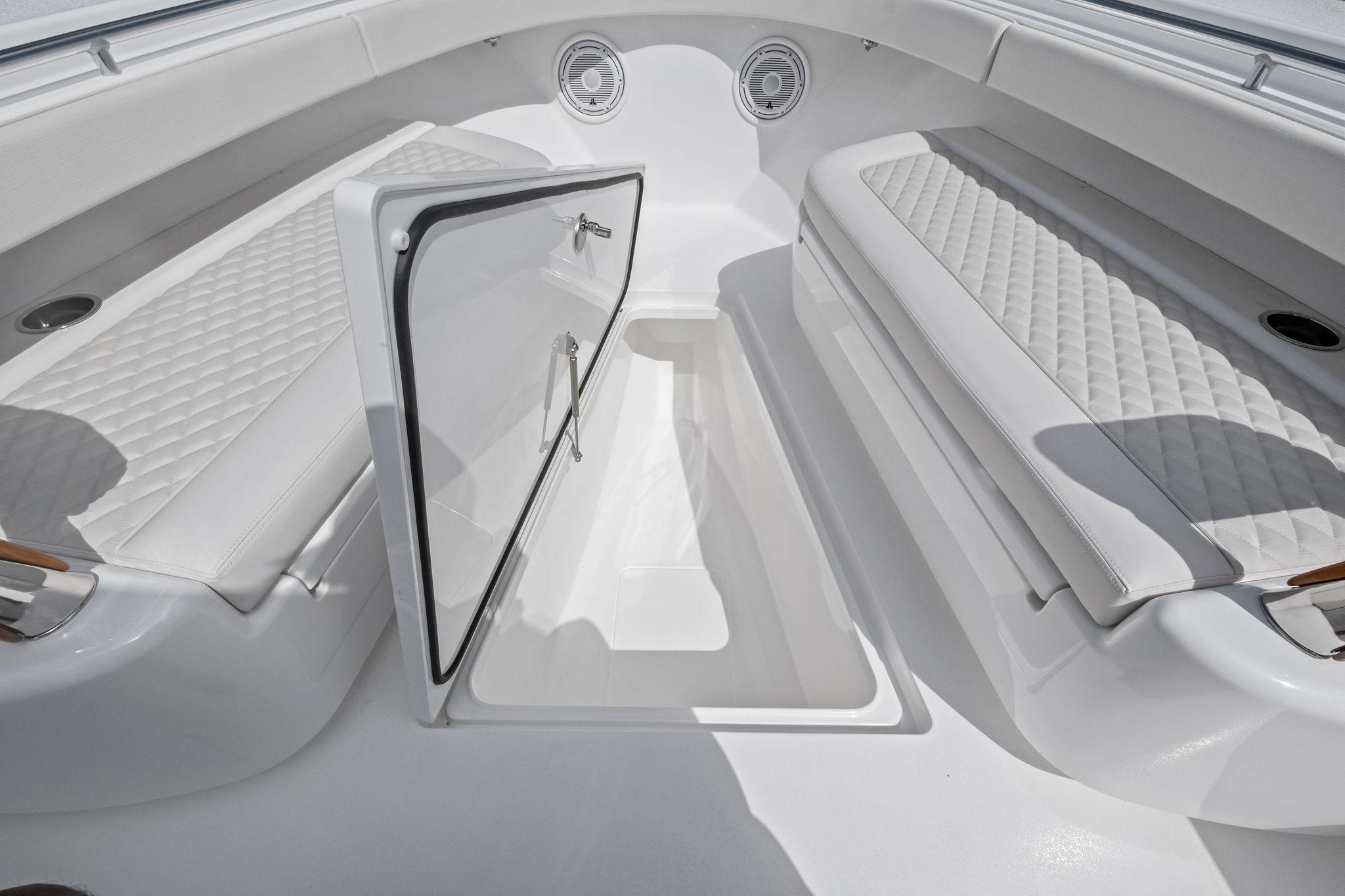 2026 Valhalla Boatworks V-37 interior with open storage compartment and cushioned seating.