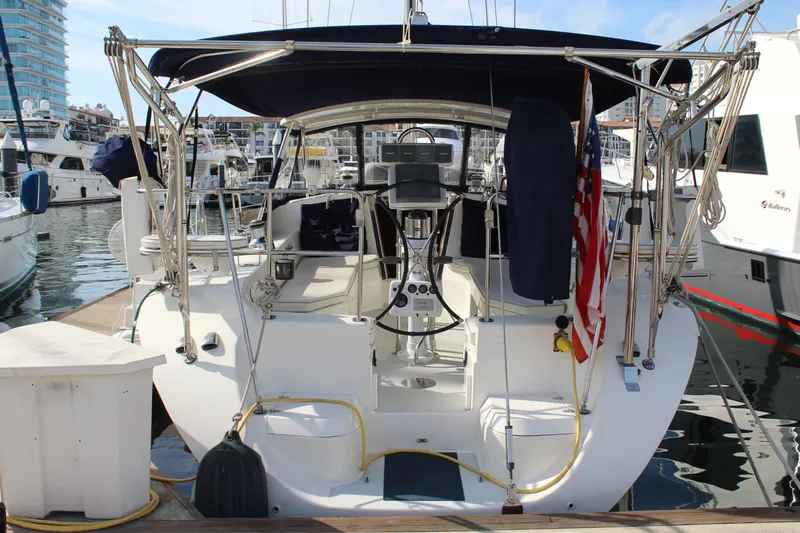 Cuckoo's Nest II Yacht Photos Pics Catalina MkII 2002 sailboat docked at marina, featuring cockpit and American flag.