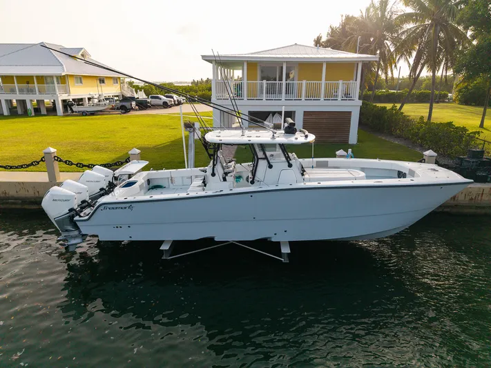  Yacht Photos Pics 2024 Freeman 38 boat docked near waterfront home with palm trees.