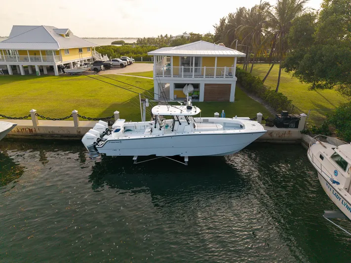  Yacht Photos Pics 2024 Freeman 38 boat docked near waterfront homes with lush greenery.