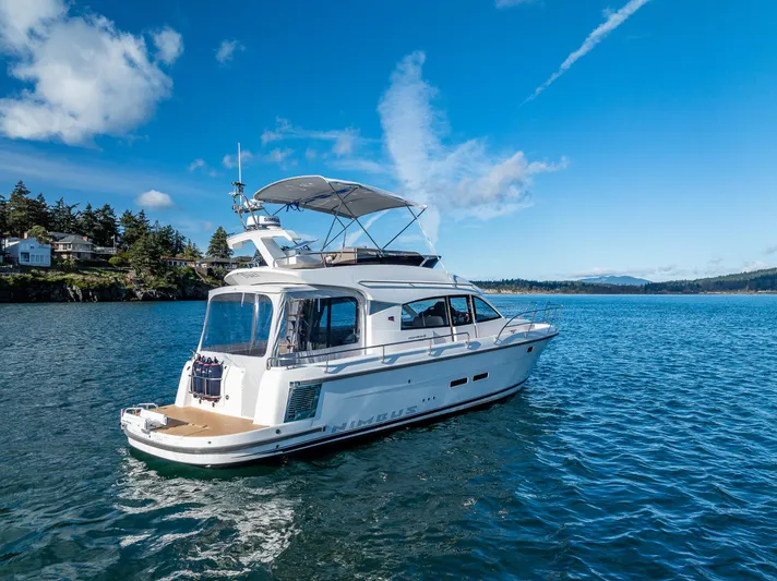 Duet Yacht Photos Pics 2024 Nimbus 405 Flybridge yacht cruising on a serene blue lake under a clear sky.