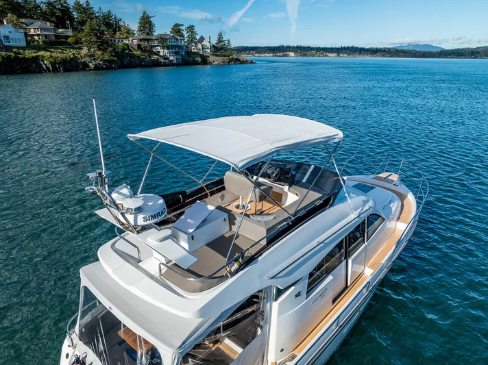 Duet Yacht Photos Pics 2024 Nimbus 405 Flybridge yacht cruising on a serene blue lake.