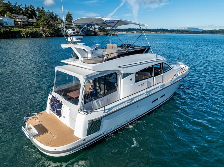 Duet Yacht Photos Pics 2024 Nimbus 405 Flybridge yacht cruising on serene blue waters.