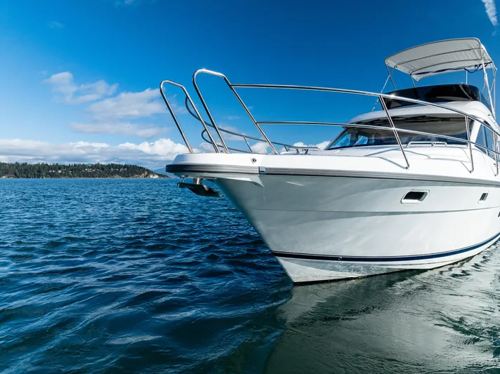 Duet Yacht Photos Pics 2024 Nimbus 405 Flybridge yacht cruising on a clear blue sea.