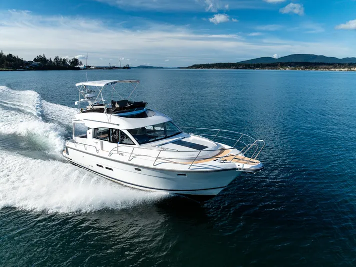Duet Yacht Photos Pics 2024 Nimbus 405 Flybridge cruising on open water under clear blue skies.