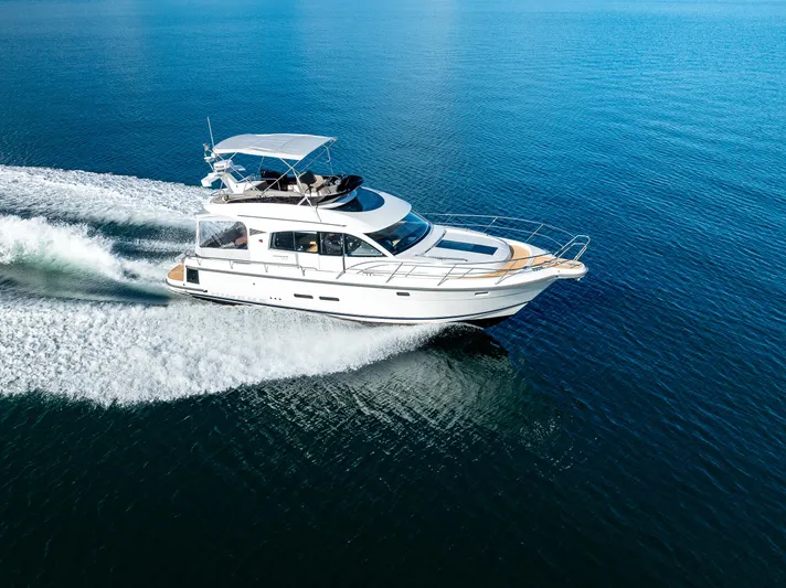 Duet Yacht Photos Pics 2024 Nimbus 405 Flybridge cruising on open water, showcasing sleek design and performance.