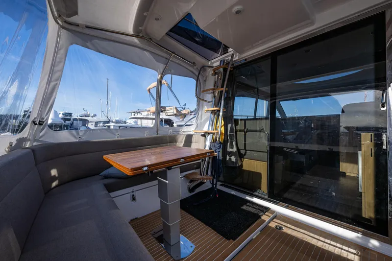 Duet Yacht Photos Pics 2024 Nimbus 405 Flybridge interior with seating, table, and marina view.