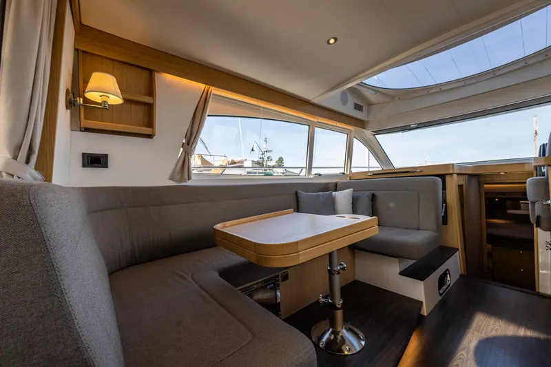 Duet Yacht Photos Pics Luxurious interior of 2024 Nimbus 405 Flybridge yacht with elegant seating and panoramic windows.