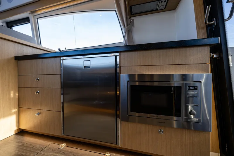 Duet Yacht Photos Pics Modern kitchen in 2024 Nimbus 405 Flybridge yacht with stainless steel appliances.