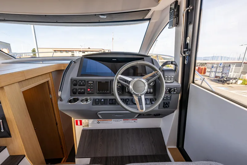 Duet Yacht Photos Pics 2024 Nimbus 405 Flybridge helm with modern controls and steering wheel.