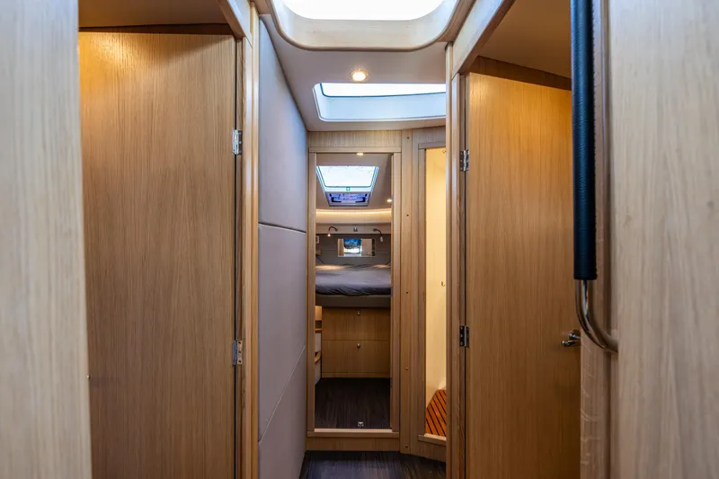 Duet Yacht Photos Pics Interior of 2024 Nimbus 405 Flybridge yacht, featuring wooden doors and cozy cabin space.