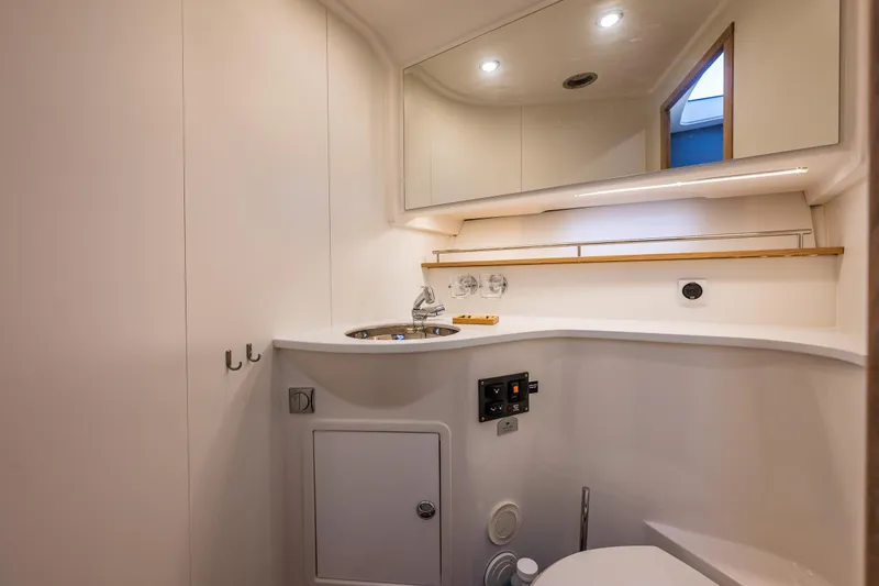 Duet Yacht Photos Pics Luxurious bathroom in 2024 Nimbus 405 Flybridge yacht with modern fixtures and elegant design.
