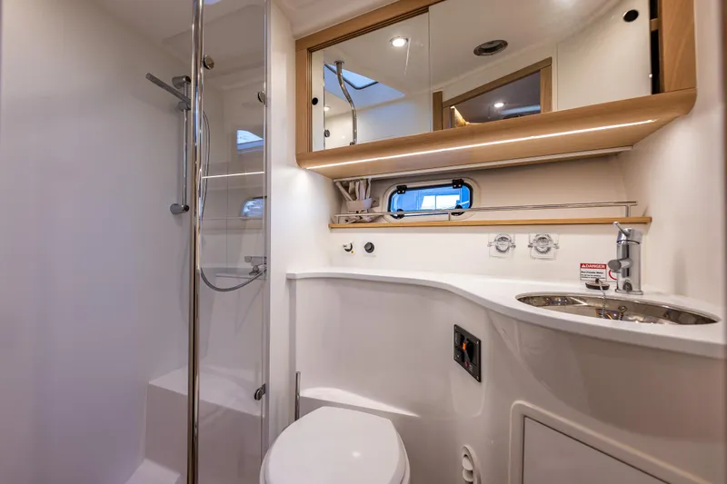 Duet Yacht Photos Pics Luxurious bathroom in 2024 Nimbus 405 Flybridge yacht with modern fixtures and elegant design.