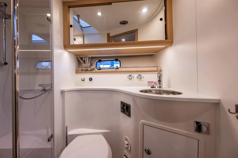 Duet Yacht Photos Pics Luxurious bathroom in 2024 Nimbus 405 Flybridge yacht with modern fixtures and elegant design.