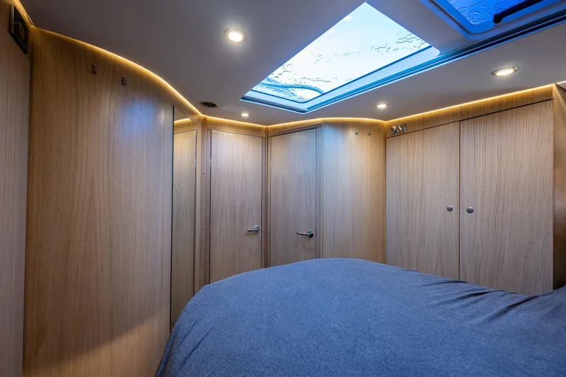 Duet Yacht Photos Pics Luxurious interior of 2024 Nimbus 405 Flybridge yacht with wood paneling and skylight.