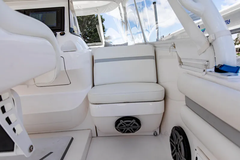  Yacht Photos Pics Interior of 2016 Intrepid 400 Cuddy boat with white seating and modern controls.