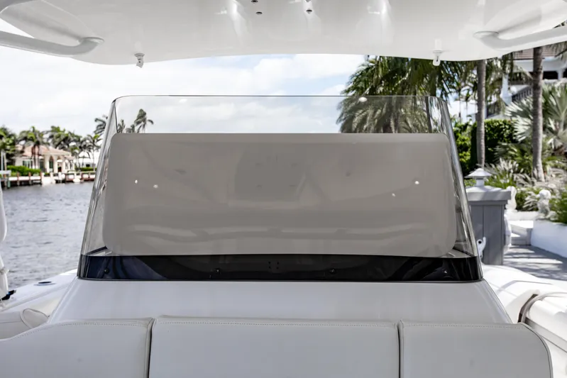  Yacht Photos Pics 2016 Intrepid 400 Cuddy boat windshield with waterfront view and palm trees.