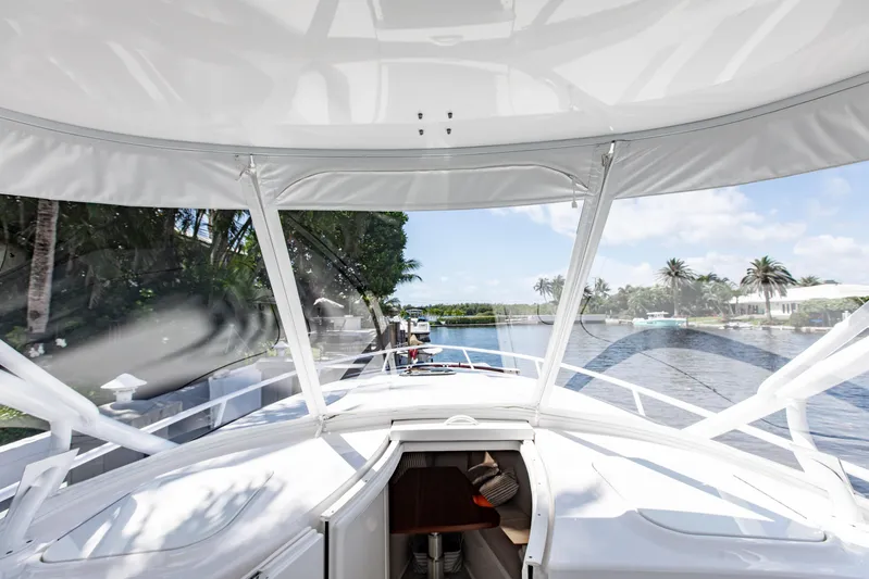  Yacht Photos Pics 2016 Intrepid 400 Cuddy boat interior with waterfront view and palm trees.