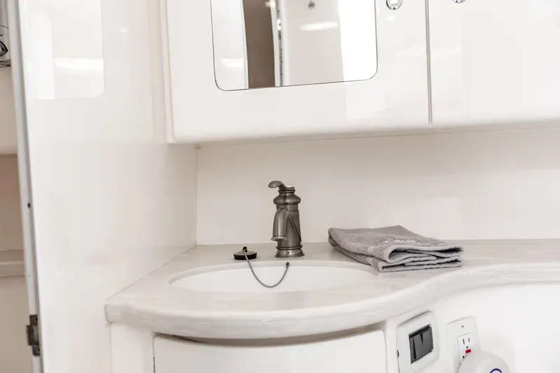  Yacht Photos Pics Intrepid 400 Cuddy 2016 boat bathroom with sink, faucet, and folded towels.