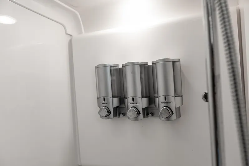  Yacht Photos Pics Wall-mounted shower dispensers in a 2016 Intrepid 400 Cuddy boat bathroom.