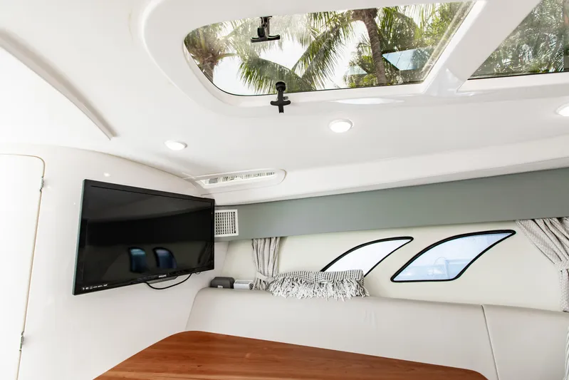  Yacht Photos Pics Interior of 2016 Intrepid 400 Cuddy with TV, skylight, and modern seating.
