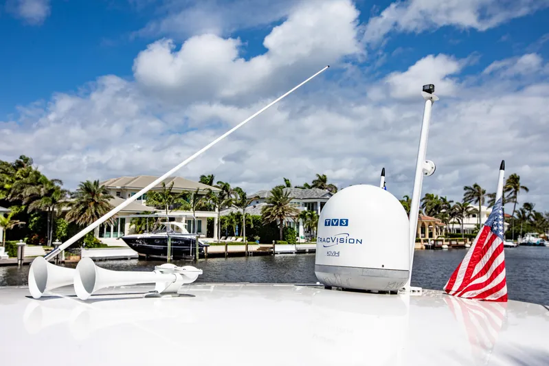  Yacht Photos Pics 2016 Intrepid 400 Cuddy boat with TracVision satellite, American flag, and waterfront homes.