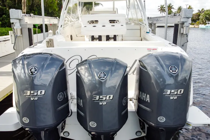  Yacht Photos Pics 2016 Intrepid 400 Cuddy with triple Yamaha 350 V8 engines docked by water.