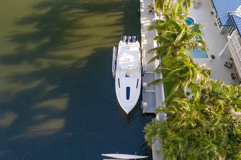  Yacht Photos Pics Aerial view of 2016 Intrepid 400 Cuddy yacht docked by palm trees.