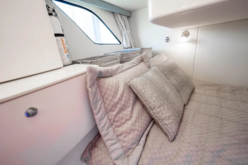  Yacht Photos Pics Cozy cabin interior of 2016 Intrepid 400 Cuddy with plush bedding and modern design.