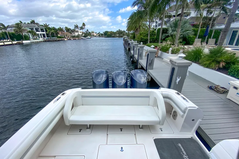  Yacht Photos Pics Intrepid 400 Cuddy 2016 docked by a scenic waterfront with palm trees.