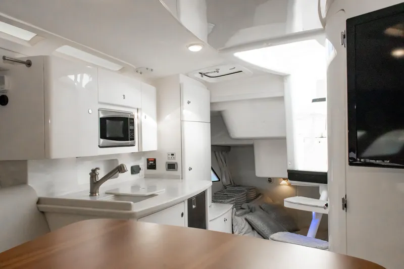  Yacht Photos Pics Interior of 2016 Intrepid 400 Cuddy boat with modern kitchen and cozy sleeping area.