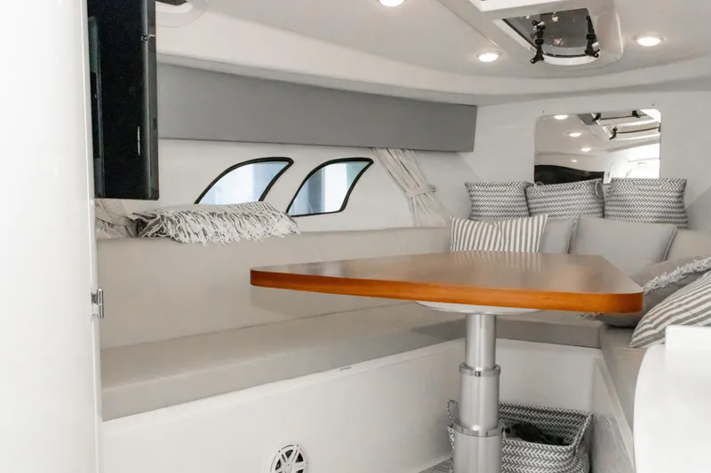 Yacht Photos Pics Interior of 2016 Intrepid 400 Cuddy with cozy seating and wooden table.