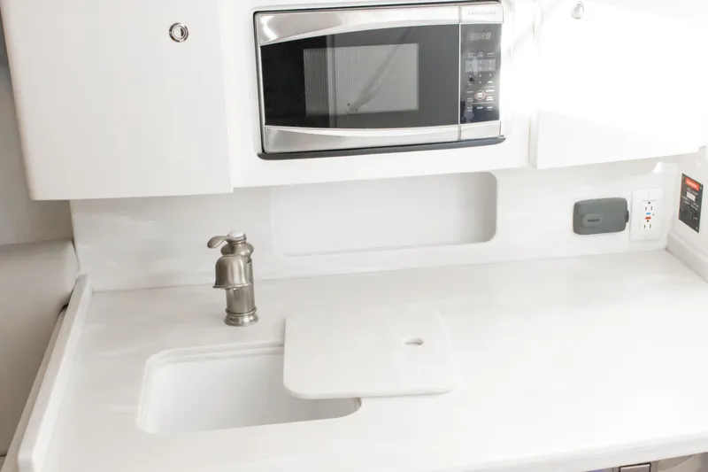  Yacht Photos Pics 2016 Intrepid 400 Cuddy kitchenette with sink, faucet, and built-in microwave.