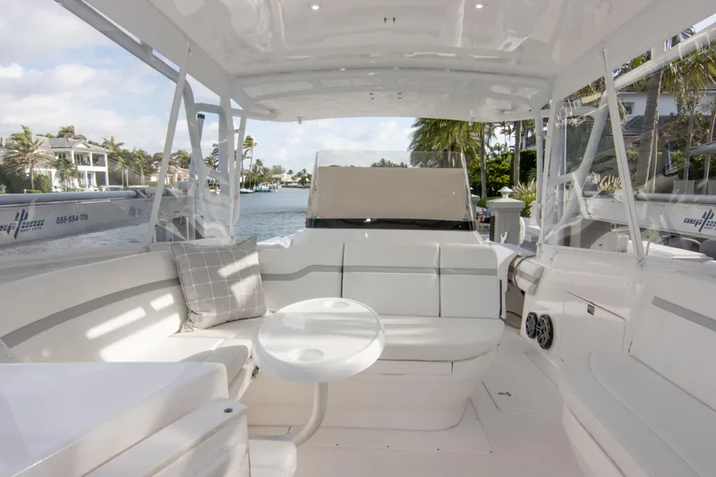  Yacht Photos Pics Luxurious 2016 Intrepid 400 Cuddy boat interior with white seating and waterfront view.