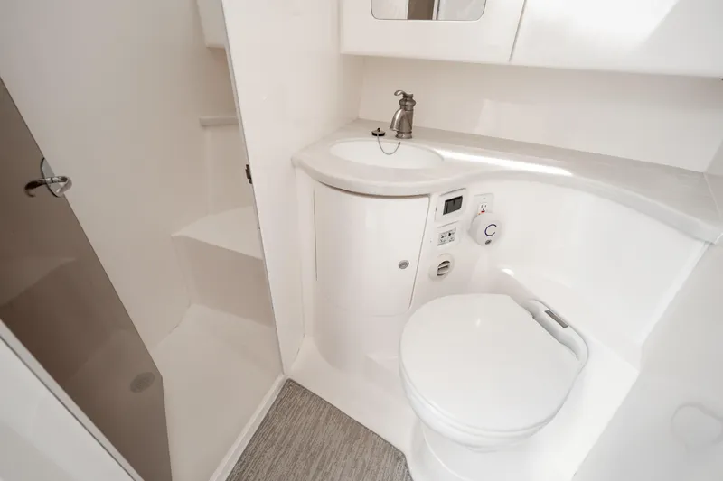  Yacht Photos Pics Luxurious 2016 Intrepid 400 Cuddy boat bathroom with modern fixtures and sleek design.