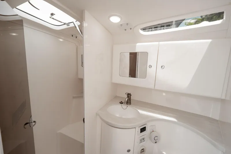  Yacht Photos Pics Luxurious bathroom interior of 2016 Intrepid 400 Cuddy boat, featuring sleek design and modern fixtures.