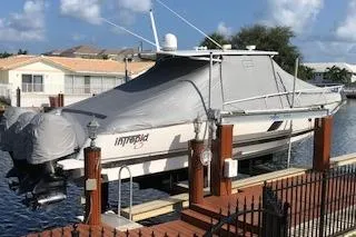  Yacht Photos Pics Covered 2016 Intrepid 400 Cuddy boat docked by waterfront homes.