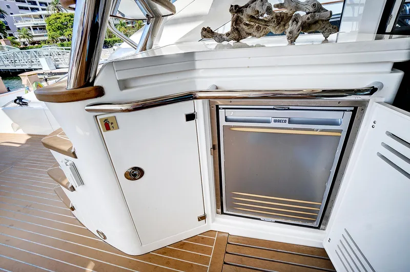 Once Around Yacht Photos Pics 2017 Sunseeker 68 Sport Yacht deck with built-in refrigerator and storage compartments.