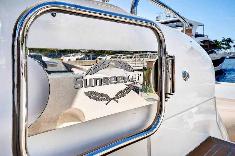 Once Around Yacht Photos Pics 2017 Sunseeker 68 Sport Yacht logo on a polished metal surface.