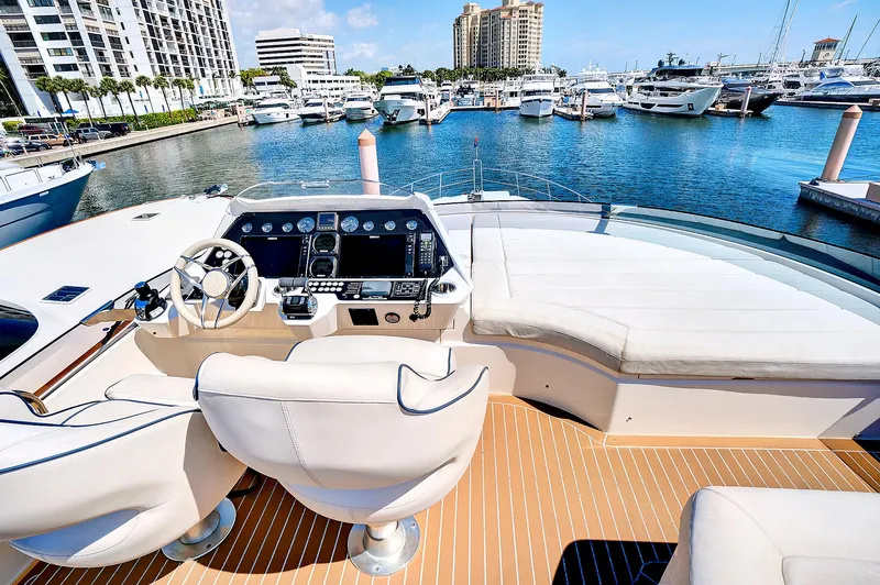 Once Around Yacht Photos Pics 2017 Sunseeker 68 Sport Yacht helm station with marina view.