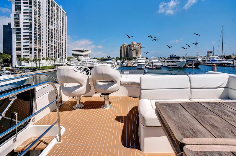 Once Around Yacht Photos Pics 2017 Sunseeker 68 Sport Yacht deck with seating, table, and marina view.