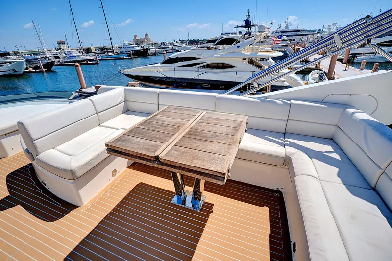 Once Around Yacht Photos Pics Sunseeker 68 Sport Yacht 2017 with spacious deck seating and wooden table at marina.