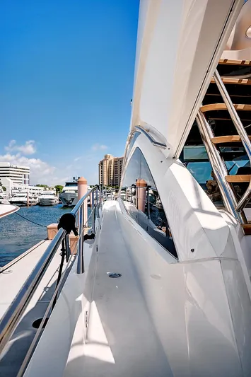 Once Around Yacht Photos Pics 2017 Sunseeker 68 Sport Yacht docked at a marina on a sunny day.