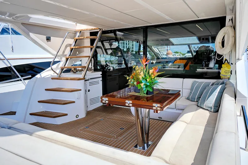 Once Around Yacht Photos Pics Luxurious 2017 Sunseeker 68 Sport Yacht interior with elegant seating and wooden table.