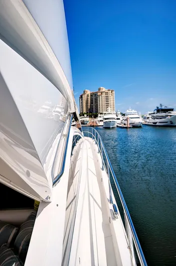 Once Around Yacht Photos Pics 2017 Sunseeker 68 Sport Yacht docked in a marina with other boats.