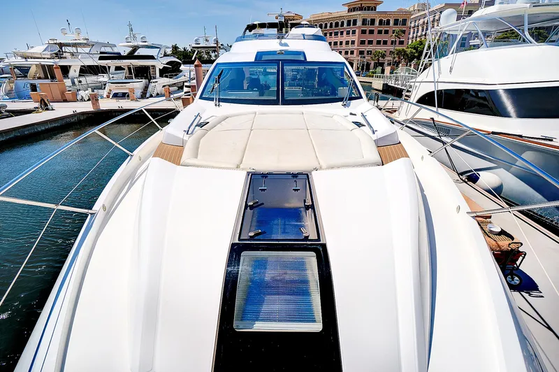 Once Around Yacht Photos Pics 2017 Sunseeker 68 Sport Yacht docked at a marina, showcasing its sleek design.